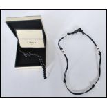 A Links of London sterling silver Teeth And Leather String necklace / bracelet , complete in box.