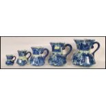 A set of five graduating 20th Century flow blue hydro water jugs in the manner of Mason's. The