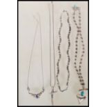 A selection of stamped 925 silver necklaces to include a snake chain necklace with a crucifix