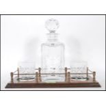 A vintage 20th Century cut glass decanter set having a stepped wooden base with a cut glass decanter
