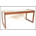A mid century, Danish influence teak wood coffee rectangular long john coffee table. Raised on