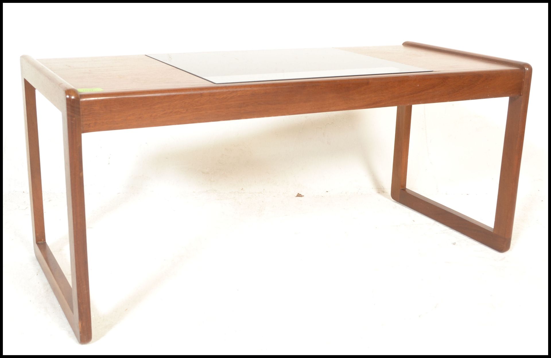 A mid century, Danish influence teak wood coffee rectangular long john coffee table. Raised on