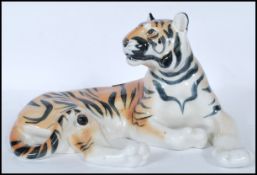 A large  20th century porcelain USSR / Russian porcelain figurine of a recumbent tiger being stamped