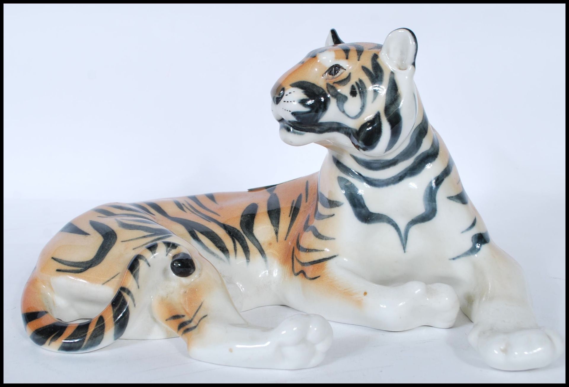 A large  20th century porcelain USSR / Russian porcelain figurine of a recumbent tiger being stamped