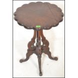 A late 19th Century high Victorian mahogany wine / occasional table, the scalloped top having