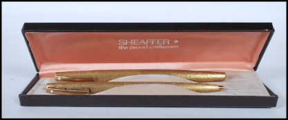 A set of two vintage Sheaffer 1970's writing pens to include a 14ct gold nib fountain pen and a