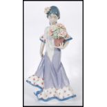 A Lladro porcelain figure entitled ' Flor Maria ' depicting a woman carrying a pot of flowers