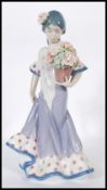 A Lladro porcelain figure entitled ' Flor Maria ' depicting a woman carrying a pot of flowers