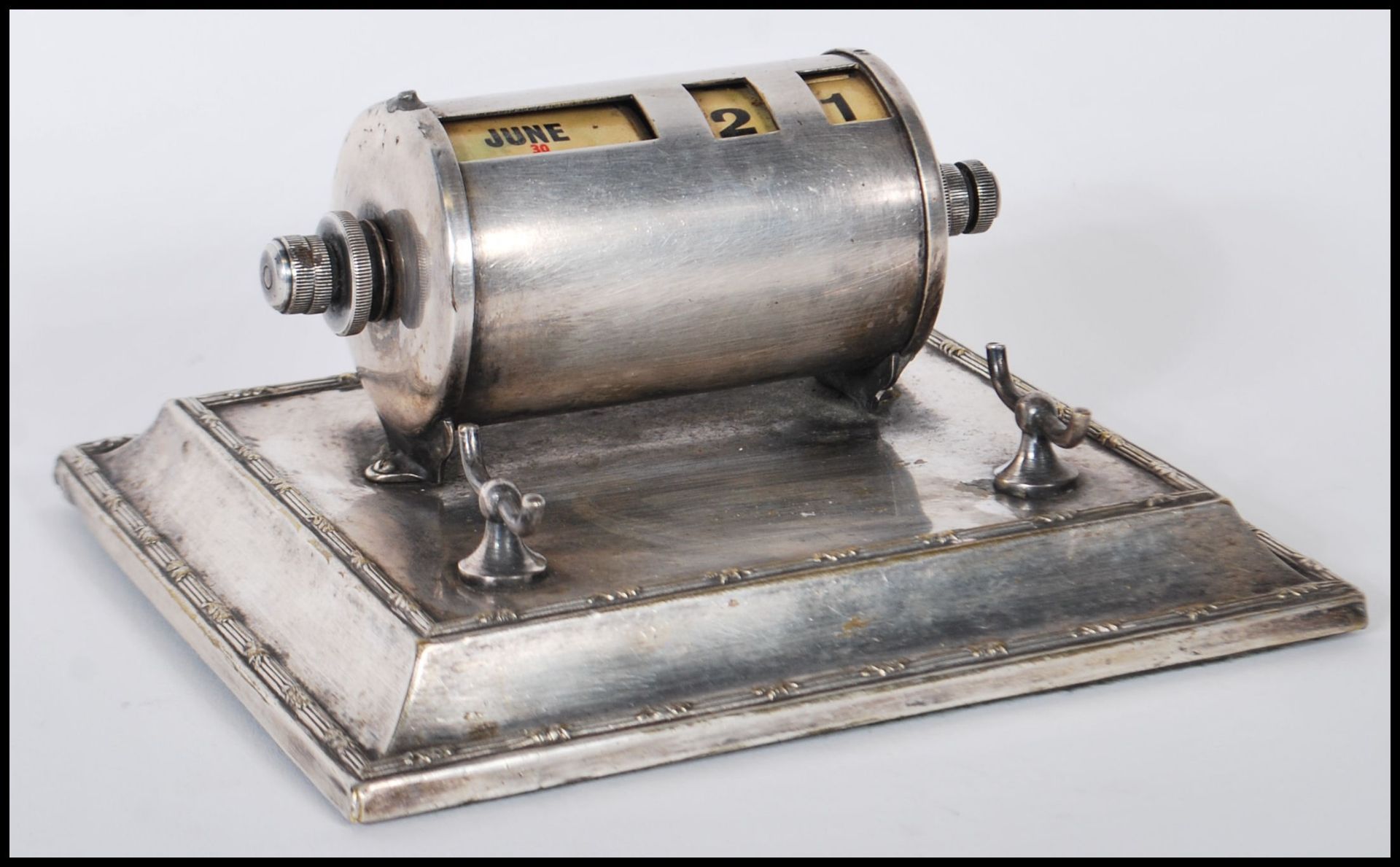 A vintage early 20th Century silver plated calendar / desk tidy having a rectangular pedestal base