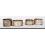 A group of four silver hallmarked napkin rings to include a scrolled acanthus leaf design ring (