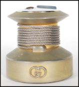 A vintage 20th Century Gucci table lighter of round form having a silvered logo to the front, and