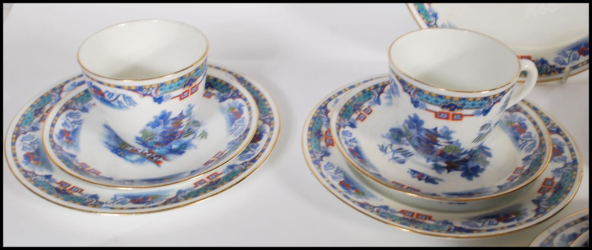 A 20th Century Staffordshire blue and white tea service in the Willow pattern, having red and - Image 2 of 8