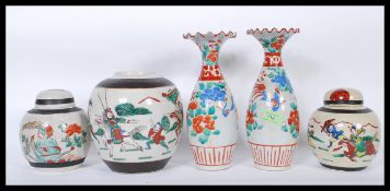 A pair of late 19th / early 20th Century Japanese vases having fanned and flared rims with hand