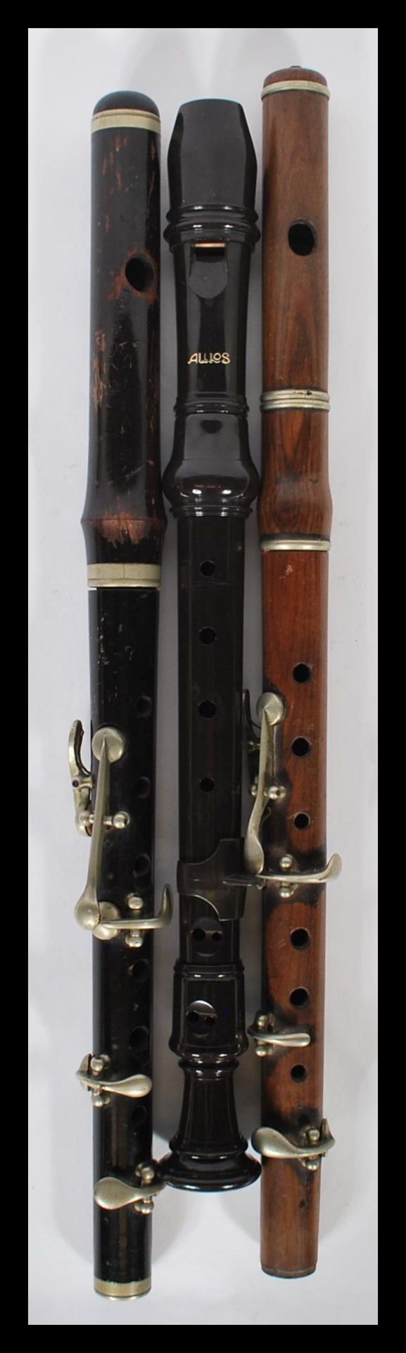 A collection of 3 vintage musical instruments to include 2 wooden mid century Piccolo and an Atlas