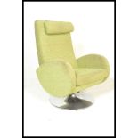 A vintage style swivel green easy armchair, scroll