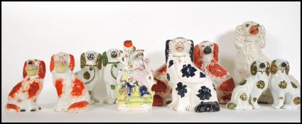 A group of ten Staffordshire fireside dogs of typical form dating from the 19th Century to include