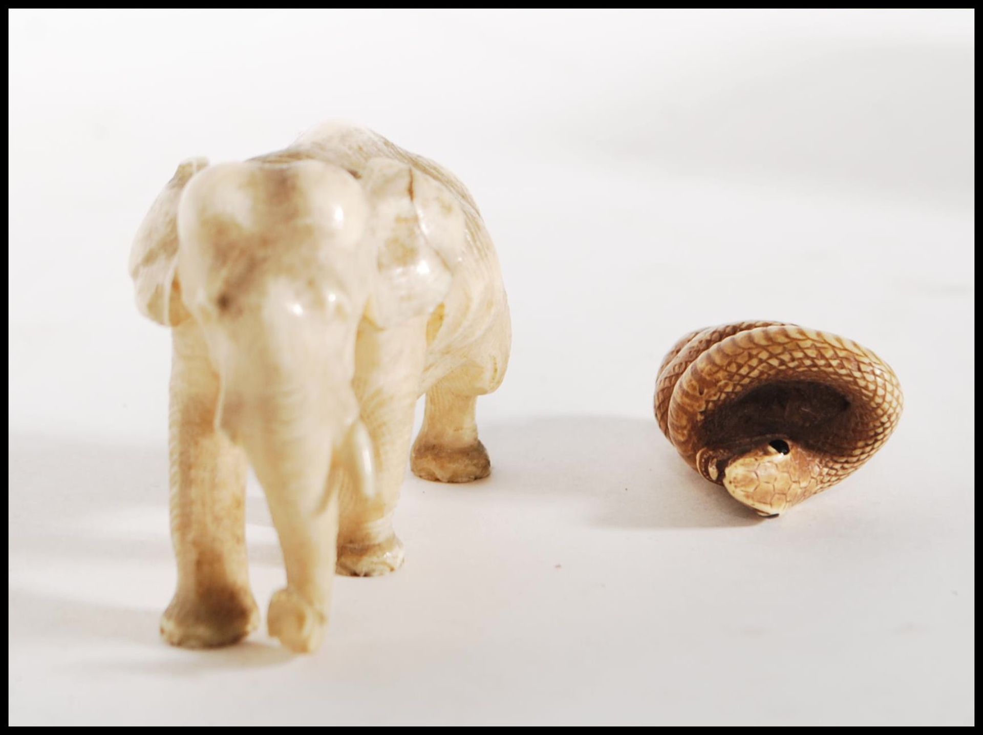 A good quality antique carved ivory figure of a elephant in a walking position. Together with a - Bild 2 aus 6