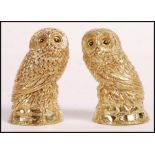 A pair of 18ct gold plated condiments in the form of owls having yellow and black glass eyes.