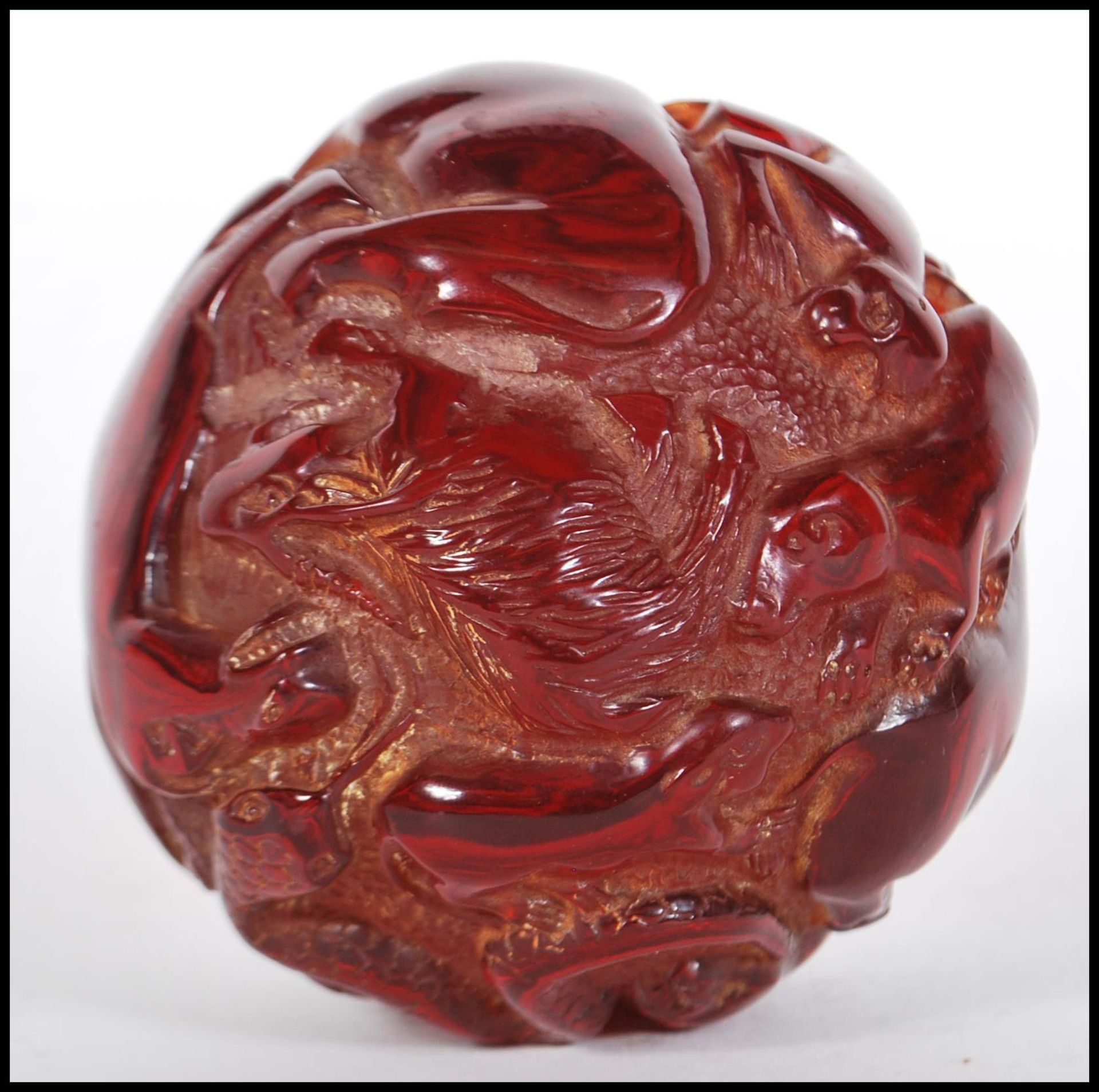 A 20th Century Chinese deep red resin sphere decorated with raised animals including a four toed - Bild 3 aus 4