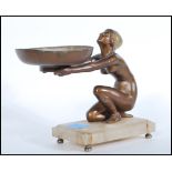 A 1930's Art Deco bronze and marble statue. The bronze kneeling lady with flapper hat holding out
