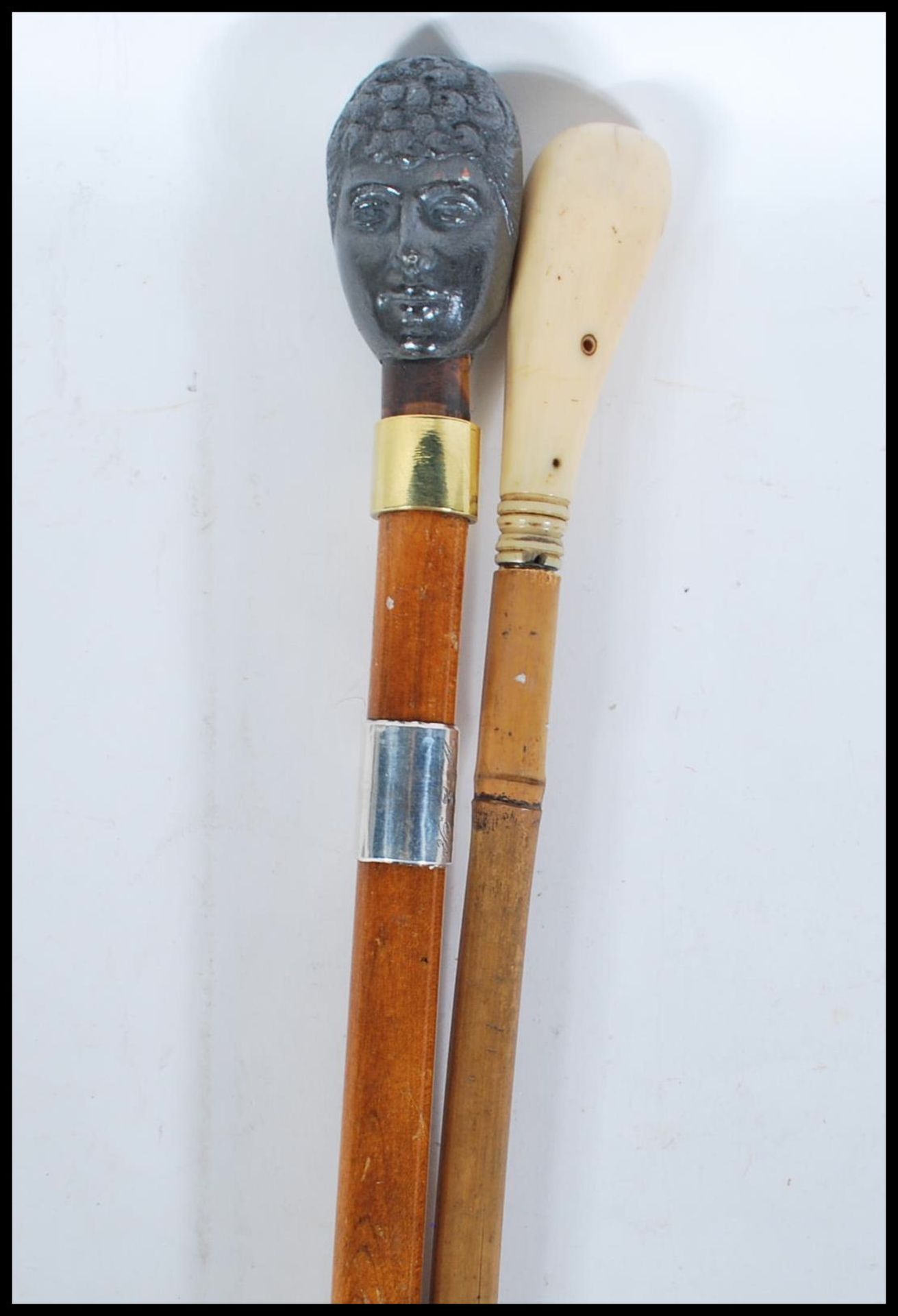 Two walking stick canes, one having knob handle in the form of King Edward VII and Queen Alexandra