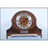 A early 20th Century Art Deco Napoleon hat oak case mantel clock having silverd dial with Arabic