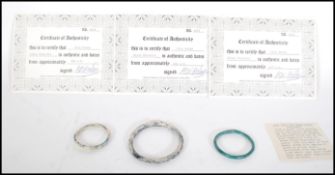 A group of three Roman blue glass bangles to include two childs bangles and one larger, believed