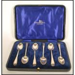 A set of cased silver hallmarked Thomas Bradbury & Sons tea spoons ( 5 ) set within a Walker &