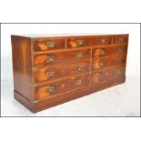 A Regency revival 20th century yew wood campaign ' Captains ' double chest of drawers. The wide body