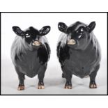 Two 20th Century Beswick ceramic figures modelled as an Aberdeen Angus Bull 1562 and Cow 1563.