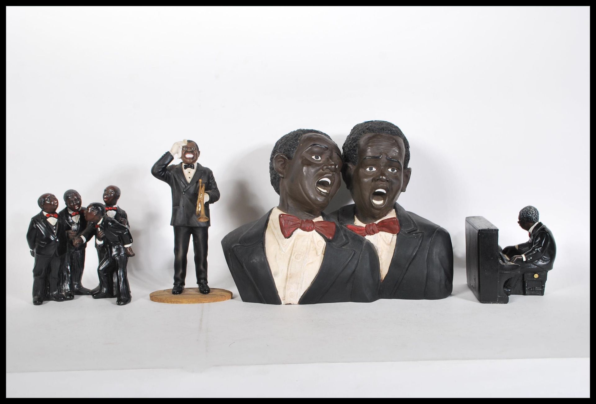 A composite figural group of black musicians together with a pianist, composite figure of Louis