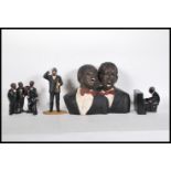 A composite figural group of black musicians together with a pianist, composite figure of Louis