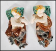 A pair of 19th Century Victorian figural majolica wall pockets in the manor of Mintons being of a