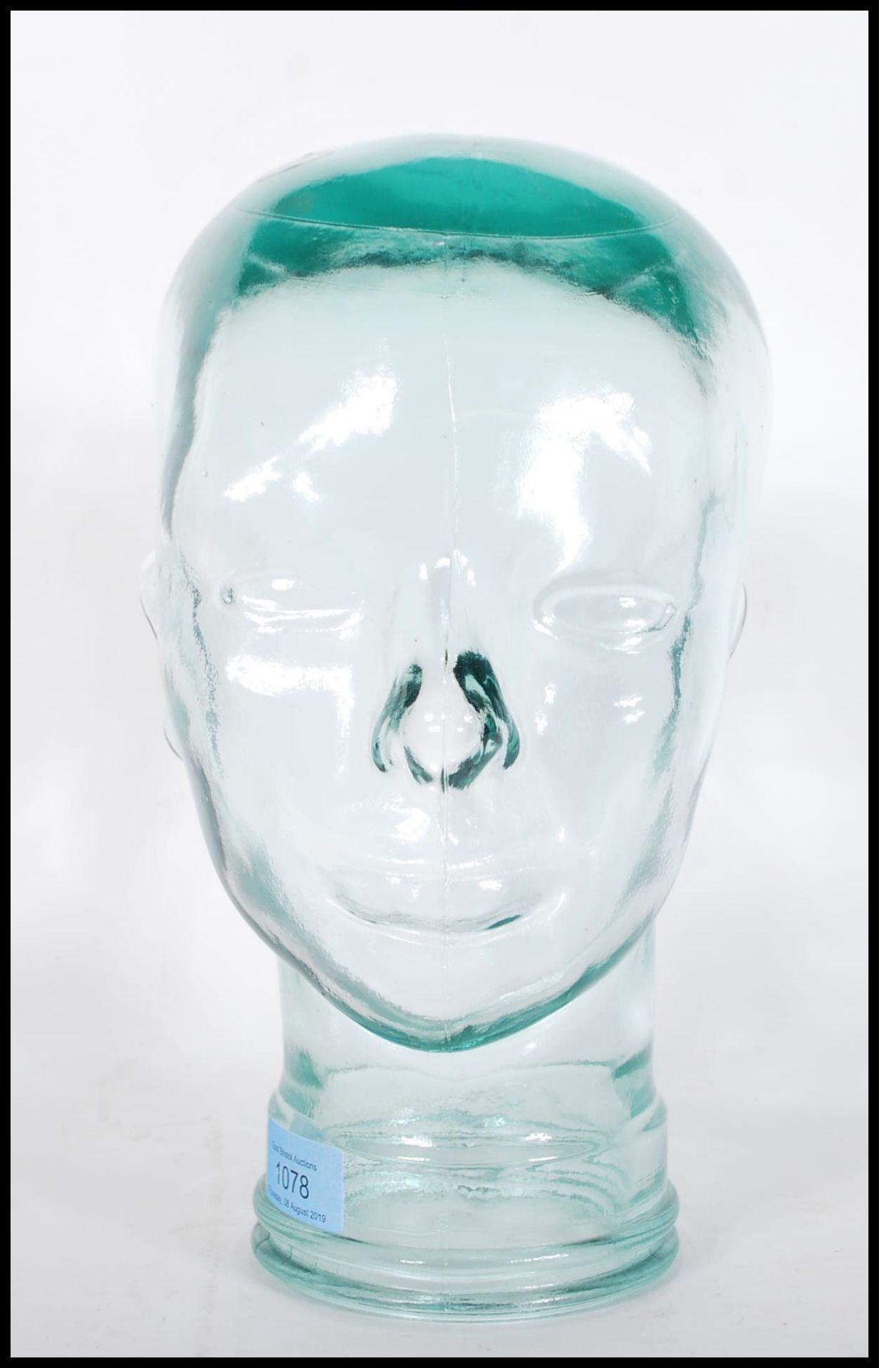 A vintage retro 20th century shop display / millinery mannequin head of pressed glass construction