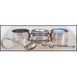 A collection of silver hallmarked items to include three napkin rings, a babies feeding /