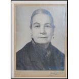 A 20th Century framed and glazed photograph of Anne Redpath OBE ARA ( Scottish artist ) being signed