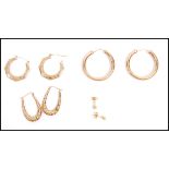 Four pairs of 9ct gold earrings. The earrings to include a large pair of hoops having etched