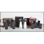 A group of three vintage binoculars to include a pair of Carl Zeiss Deltrintem 8 x 30 binoculars and