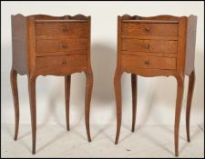 A pair of early 20th century French oak bedside tables / cabinets. Each raised on sabre legs with