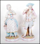 A pair of late 19th / early 20th Century French Continental Bisque ware figurines depicting a