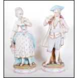 A pair of late 19th / early 20th Century French Continental Bisque ware figurines depicting a