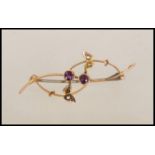 A 9ct gold Victorian brooch with wire work roundles set with two central amethyst and butterflies