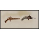 A 19th Century German miniature firing cap gun / pistol having engraved hilt and articulated