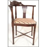 An Edwardian mahogany framed corner chair / armchair with recently re-upholstered seat pad seat