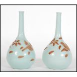A pair of 19th Century Japanese slip decorated celadon stem vases being onion shaped. Each decorated