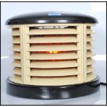A post war Art Deco  century HMV 'Cavendish' demi-lune electric fan heater having bakelite top and