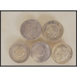 A group of five Chinese silver coins all being dragon coins, various leaders and character marks,