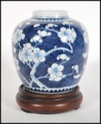 A early 20th Century Chinese blue and white ginger jar and cover hand decorated in the prunus