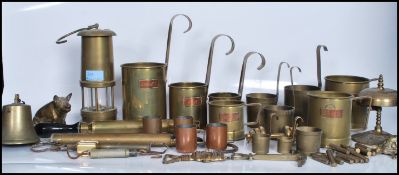 A collection of vintage 20th Century brass wares to include a Welsh miners lamp, spirit measures,