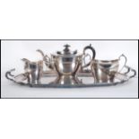 A silver plated tray of rectangular form with a scrolled moulded rim and twin carrying handles,